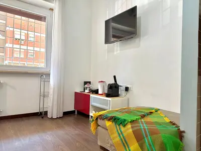 a room with a bed and a tv on a wall at Oasi Majorana in Rome