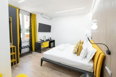 a hotel room with a bed and a desk at Olimpico Luxury Rooms in Rome