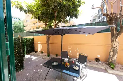 a table with an umbrella on a patio at Olimpico Luxury Rooms in Rome