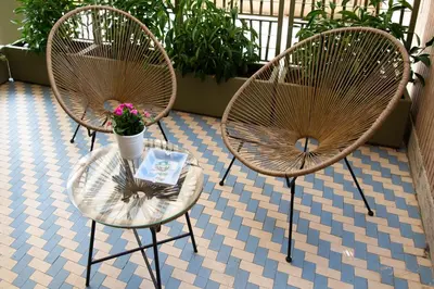 two chairs and a table with a vase of flowers at Melodies Of Rome in Rome