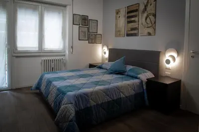 a bedroom with a bed and two lamps and a window at Melodies Of Rome in Rome