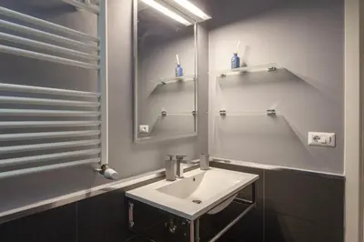 a bathroom with a sink and a mirror at Vatican Luxury Three Bedroom Apartment in Rome