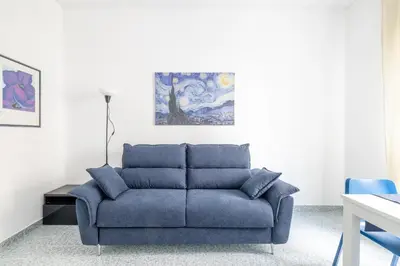 a blue couch sitting in a living room at Atelier Latino in Rome