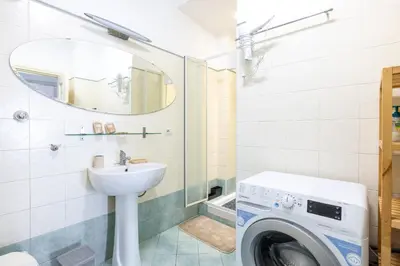 a bathroom with a washing machine and a sink at Atelier Latino in Rome