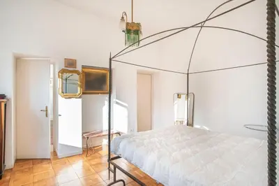 a bedroom with a bed with a canopy at Urban Terrace Merulana - by OpenRoma in Rome