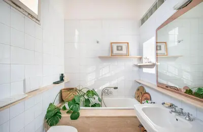 a white bathroom with a tub and a sink at Urban Terrace Merulana - by OpenRoma in Rome