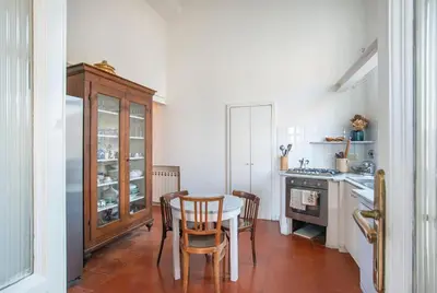 a kitchen with a table and chairs and a counter at Urban Terrace Merulana - by OpenRoma in Rome