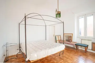 a bedroom with a canopy bed and a table at Urban Terrace Merulana - by OpenRoma in Rome