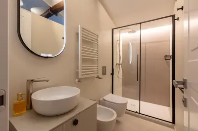 a bathroom with a sink and a toilet and a mirror at Decòncept House in Rome