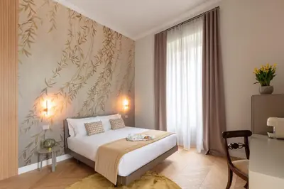 a bedroom with a bed and a wall with plants at Decòncept House in Rome