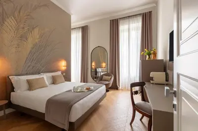 a hotel room with a bed and a chair at Decòncept House in Rome
