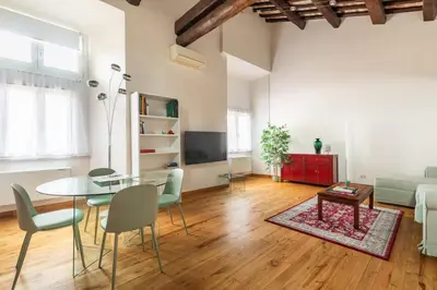 a living room with a glass table and chairs at Pantheon Palace Loft by RomeLoft in Rome