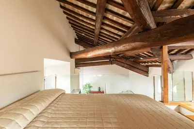 a large bed in a room with wooden ceilings at Pantheon Palace Loft by RomeLoft in Rome