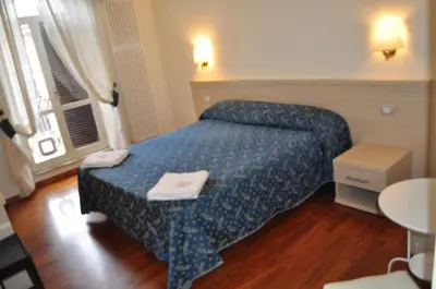 a hotel room with a bed and a table and a window at Karina Suite in Rome