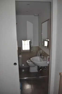 a bathroom with a toilet and a sink and a mirror at Karina Suite in Rome