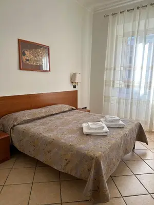 a bedroom with a bed with two towels on it at Karina Suite in Rome