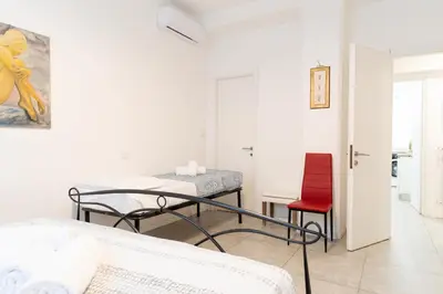 a living room with a table and a couch at Jubilee Metro A 15 minutes from the Colosseum in Rome