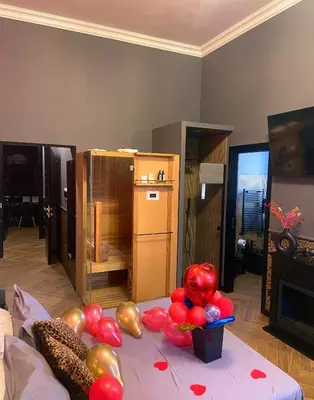 a room with a table with balloons on it at One of one Experiences - LOVE SPA SUITE in Rome