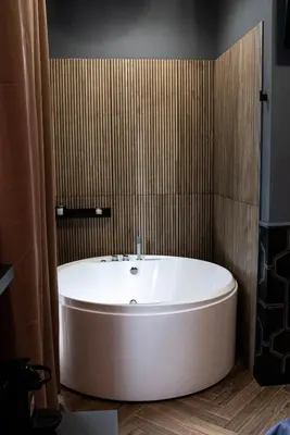 a large white bath tub in a bathroom at One of one experiences - LOVE ROOM in Rome