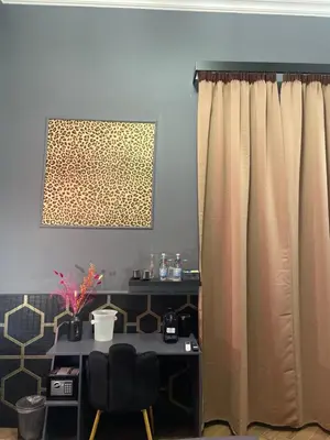 a table and two chairs in a room with a curtain at One of one experiences - LOVE ROOM in Rome