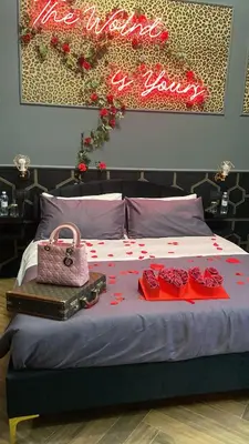 a bed with a sign that reads we want to love at One of one experiences - LOVE ROOM in Rome