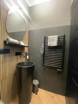 a bathroom with a sink and a mirror at One of one Experiences - CINEMA ROOM in Rome
