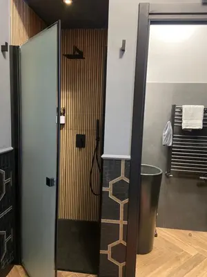 a bathroom with a shower and a trash can at One of one Experiences - CINEMA ROOM in Rome
