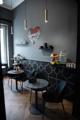 a restaurant with two tables and a heart on the wall at One of one Experiences - CINEMA ROOM in Rome
