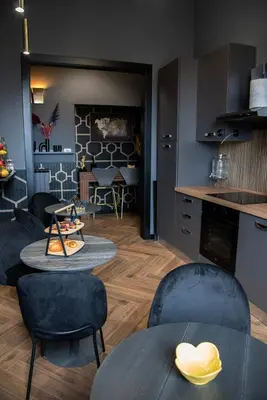 a kitchen and living room with tables and chairs at One of one Experiences - CINEMA ROOM in Rome
