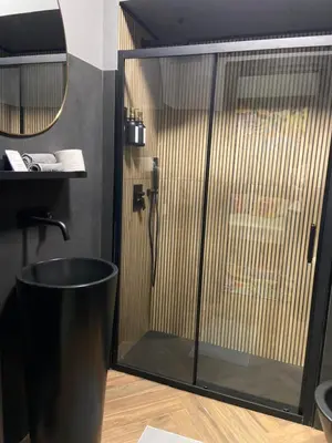 a shower with a glass door in a bathroom at One of one experiences - ART ROOM in Rome