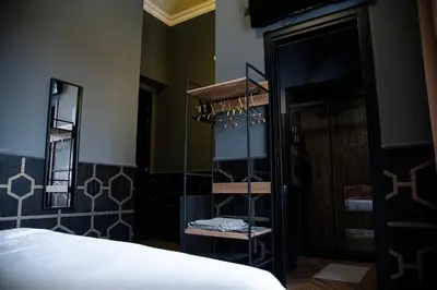 a bedroom with a bed and a mirror and a closet at One of one experiences - ART ROOM in Rome