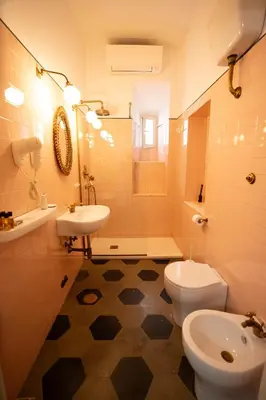 a bathroom with a sink and a toilet and a shower at 101 Flats Candia's Suites in Rome