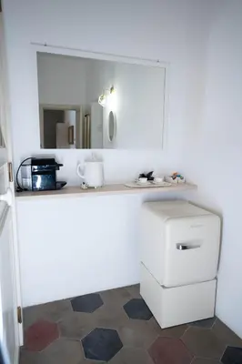 a kitchen with a counter with a sink and a mirror at 101 Flats Candia's Suites in Rome