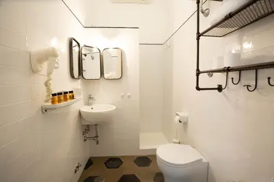 a white bathroom with a toilet and a sink at 101 Flats Candia's Suites in Rome