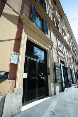 a building with glass doors on the side of it at 101 Flats Candia's Suites in Rome