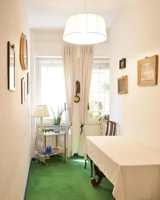 a bedroom with a bed and a window and green carpet at Home in Parioli in Rome