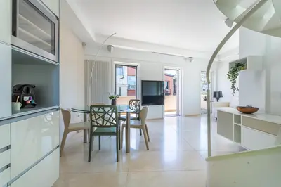a kitchen and dining room with a table and chairs at iFlat Spanish Steps Unique Panoramic Penthouse in Rome