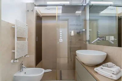 a bathroom with a sink and a glass shower at iFlat Spanish Steps Unique Panoramic Penthouse in Rome