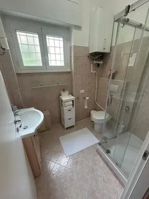 a bathroom with a shower and a toilet and a sink at Casa Garbata in Rome