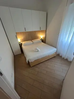 a small bedroom with a bed and two lights at Casa Garbata in Rome