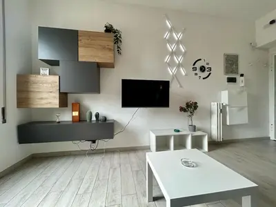 a living room with a flat screen tv on the wall at Aurum Homes - Vaticano Lux Appartament in Rome