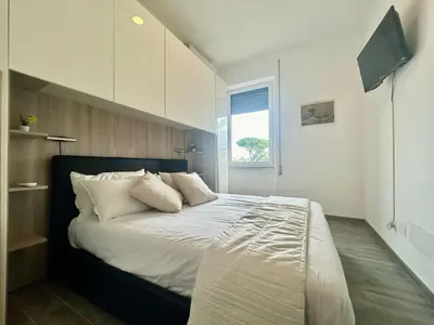 a bedroom with a large bed with white pillows at Aurum Homes - Vaticano Lux Appartament in Rome