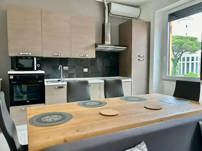 a kitchen with a wooden table with chairs around it at Aurum Homes - Vaticano Lux Appartament in Rome