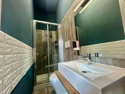 a bathroom with a sink and a shower and a toilet at Aurum Homes - Vaticano Lux Appartament in Rome