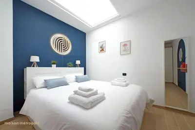 a bedroom with a white bed with towels on it at Color House, roof garden & parking in Rome