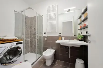 a bathroom with a washing machine and a sink at Color House, roof garden & parking in Rome