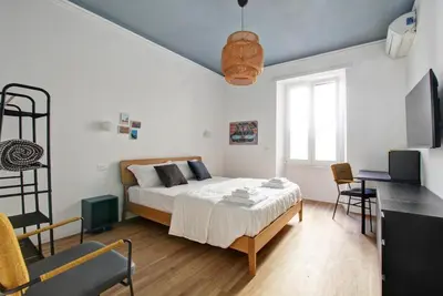 a bedroom with a bed and a table and chairs at Roma Academia Style by the Halls of Knowledge in Rome