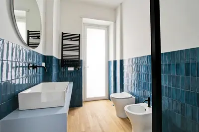 a bathroom with a sink and a toilet and a mirror at Roma Academia Style by the Halls of Knowledge in Rome