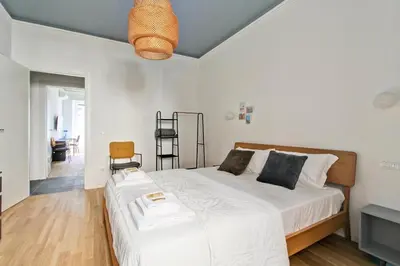 a bedroom with a large bed with white sheets at Roma Academia Style by the Halls of Knowledge in Rome