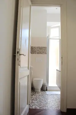a bathroom with a toilet and a door open at Porta del Vaticano in Rome